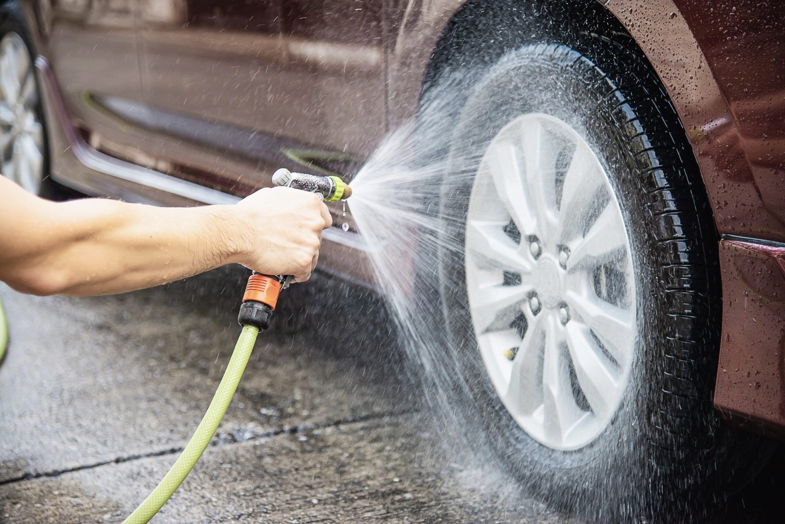 Man washing car using shampoo and water - home people car clean concept